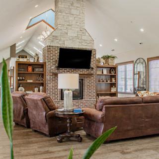 A beautifully designed living room featuring a modern fireplace, cozy seating, and ample natural light.