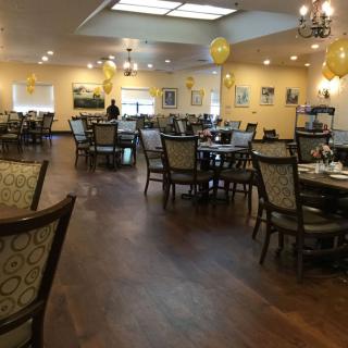 A spacious dining area with elegant furniture and festive decorations.