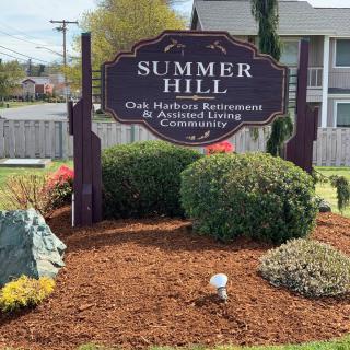 Entrance sign for Summer Hill, a retirement and assisted living community, surrounded by well-maintained landscaping.