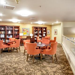 A cozy lounge area with bookshelves and comfortable seating.