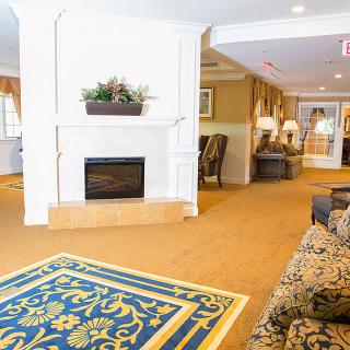 A cozy hotel lobby with a fireplace and comfortable seating.