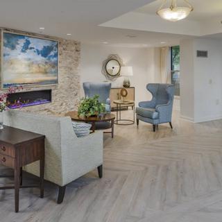A modern living room featuring stylish armchairs, a fireplace, and decorative elements.