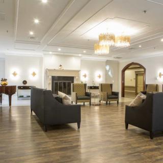 A spacious and elegantly decorated lobby with modern furnishings and lighting.