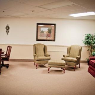 A waiting area with chairs, a table, and decorative elements.