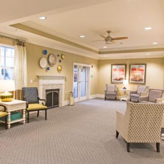 A cozy living room with comfortable seating, a fireplace, and warm lighting.