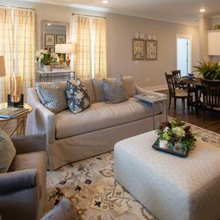 A cozy and elegantly designed living room with a sofa, coffee table, and decorative elements.