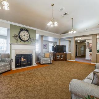 A spacious living room with a fireplace and classic decor.