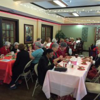 A group of people enjoying a social gathering in a decorated indoor space.