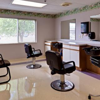A clean and modern hair salon interior featuring styling chairs and large mirrors.