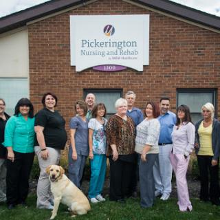 The dedicated team at Pickerington Nursing and Rehab, with their loyal canine companion.