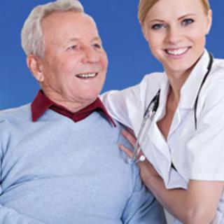 A nurse smiling next to an elderly man, providing care and support.