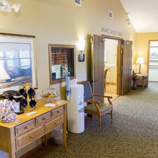 A cozy reception area with seating and a water cooler.