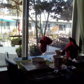 A cozy dining table with a view of the outdoor courtyard.