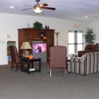 A cozy living room with comfortable seating and a television.