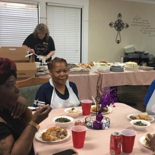 A group of people enjoying a meal together at a community gathering.