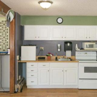 A modern kitchen with white cabinets and various appliances.