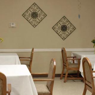 A quiet dining area with tables and chairs, decorated with wall art.