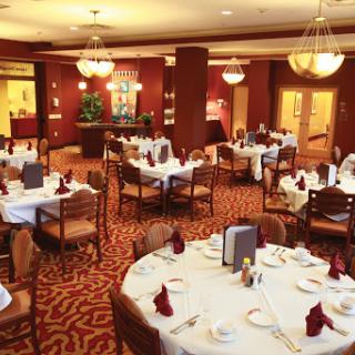 An elegant restaurant interior featuring neatly arranged tables and a warm atmosphere.