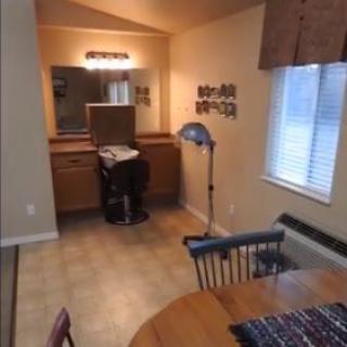 A cozy dining area with a table, chairs, and adjacent mirror setup.