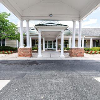 A covered entrance with columns leading to a building.