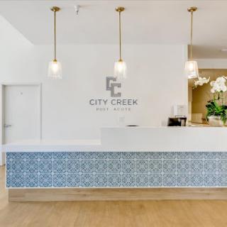 A stylish reception area featuring a modern design with blue tiled accents.