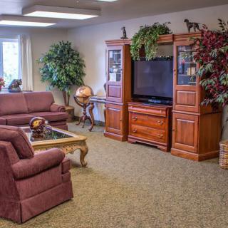 A cozy living room with comfortable seating and a large entertainment center.