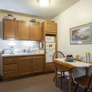 A cozy kitchen area with wooden cabinets and a small dining table.