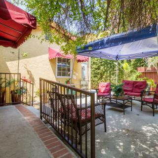 A cozy outdoor patio with comfortable seating and a canopy for shade.