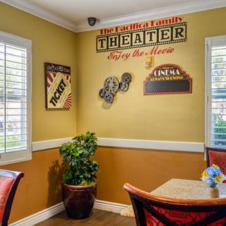 A cozy corner with theater-themed wall decor and seating.