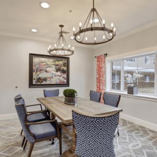 A stylish dining room with elegant chandeliers and modern decor.