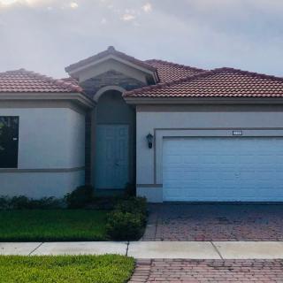 A suburban house with a tiled roof and attached garage.