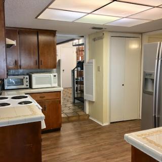 A spacious kitchen featuring wooden cabinets and modern appliances.