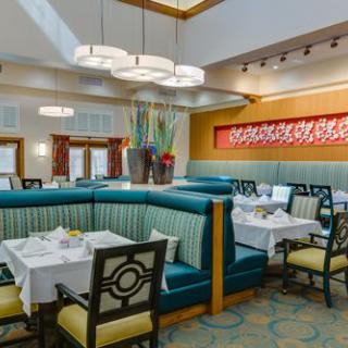 A stylish restaurant interior featuring arranged seating and elegant decor.