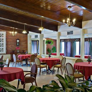 A cozy restaurant interior featuring red tablecloths and classic decor.