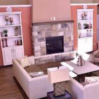 A cozy living room featuring a central fireplace, comfortable sofas, and built-in bookshelves.