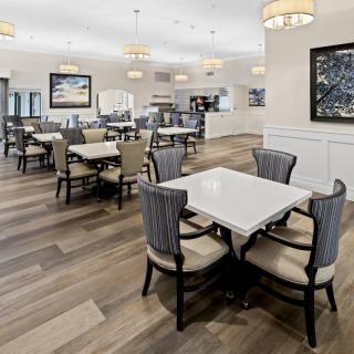 A modern dining area with elegant furnishings and contemporary lighting.
