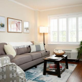 A cozy living room with a comfortable sofa, coffee table, and warm lighting.
