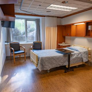 A well-lit and organized hospital room equipped for patient care.