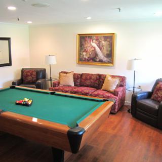 A cozy living room with a pool table and stylish furniture.