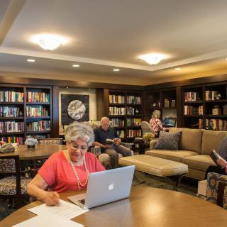 People studying and relaxing in a cozy library setting.