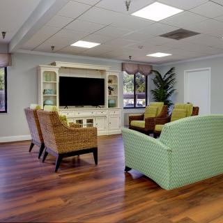 A cozy living room with comfortable seating and a large television.