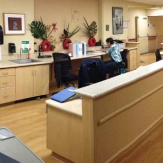 A nurse station in a hospital with desks and medical equipment.