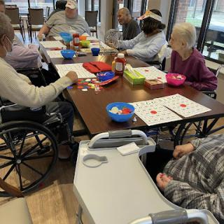 A lively bingo game session among elderly residents in a community center.