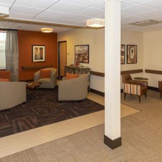 A cozy lounge area with comfortable seating and artwork on the walls.