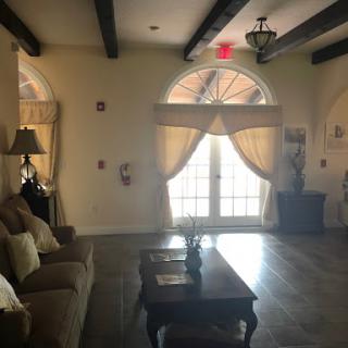 A cozy living room bathed in natural light, featuring elegant curtains and comfortable furniture.
