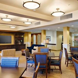 A spacious and well-lit community lounge area with comfortable seating and modern decor.