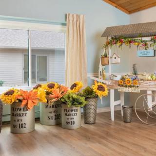 A quaint interior space featuring rustic flower arrangements with vibrant sunflowers and decorative elements.