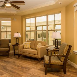 A cozy living room with comfortable seating and warm lighting.