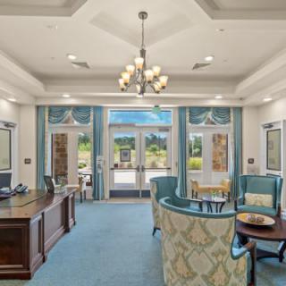 A bright and welcoming lobby with a reception desk and comfortable seating.