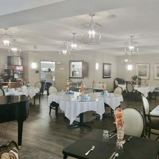 A beautifully arranged dining area featuring elegant tables and tasteful lighting.